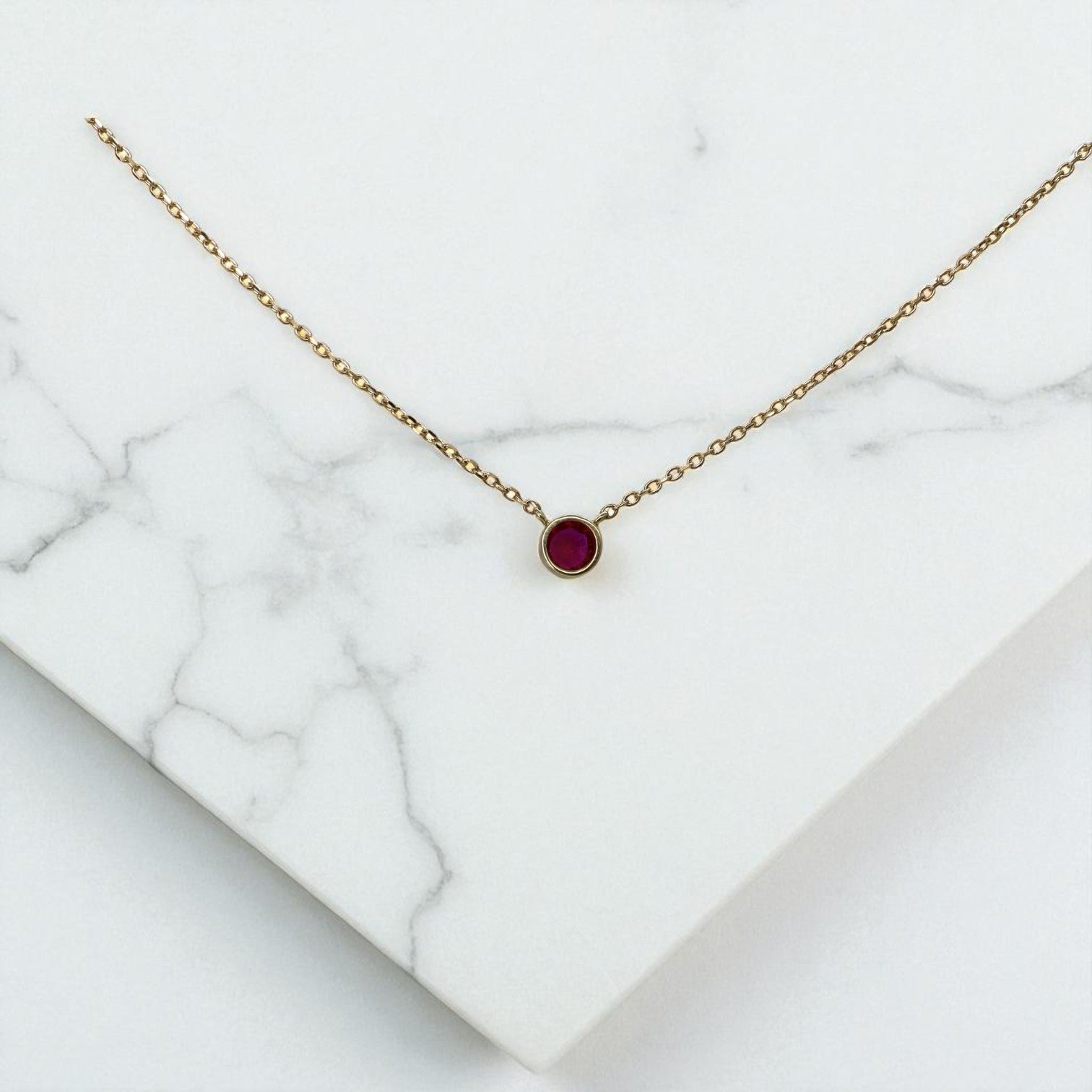 Petra Star ruby necklace featuring vibrant red gemstones on a delicate chain, perfect for elegant jewelry styling.