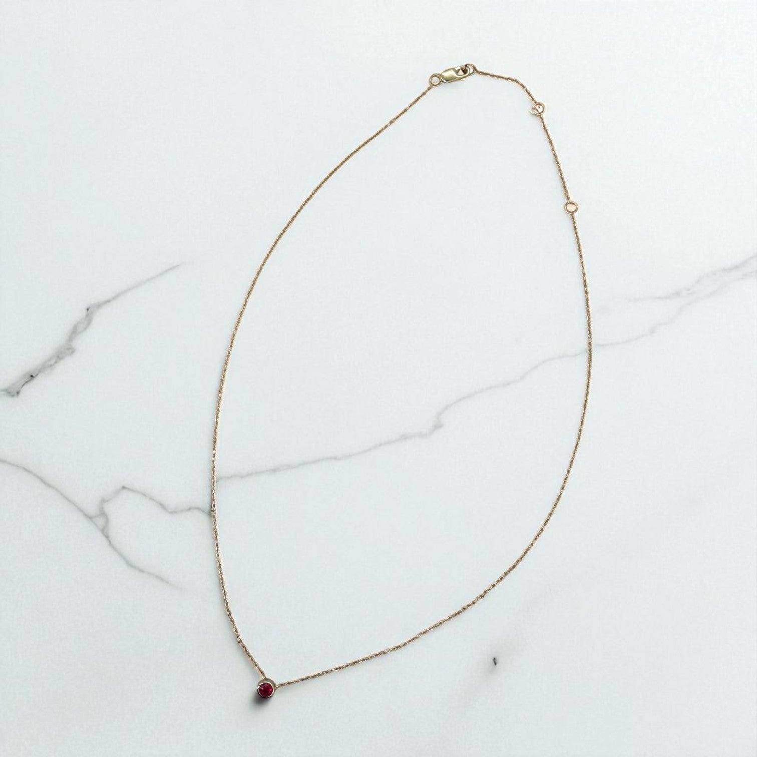 Petra Star Ruby Necklace featuring a vibrant red gemstone pendant on a delicate chain, showcasing elegant jewelry design.