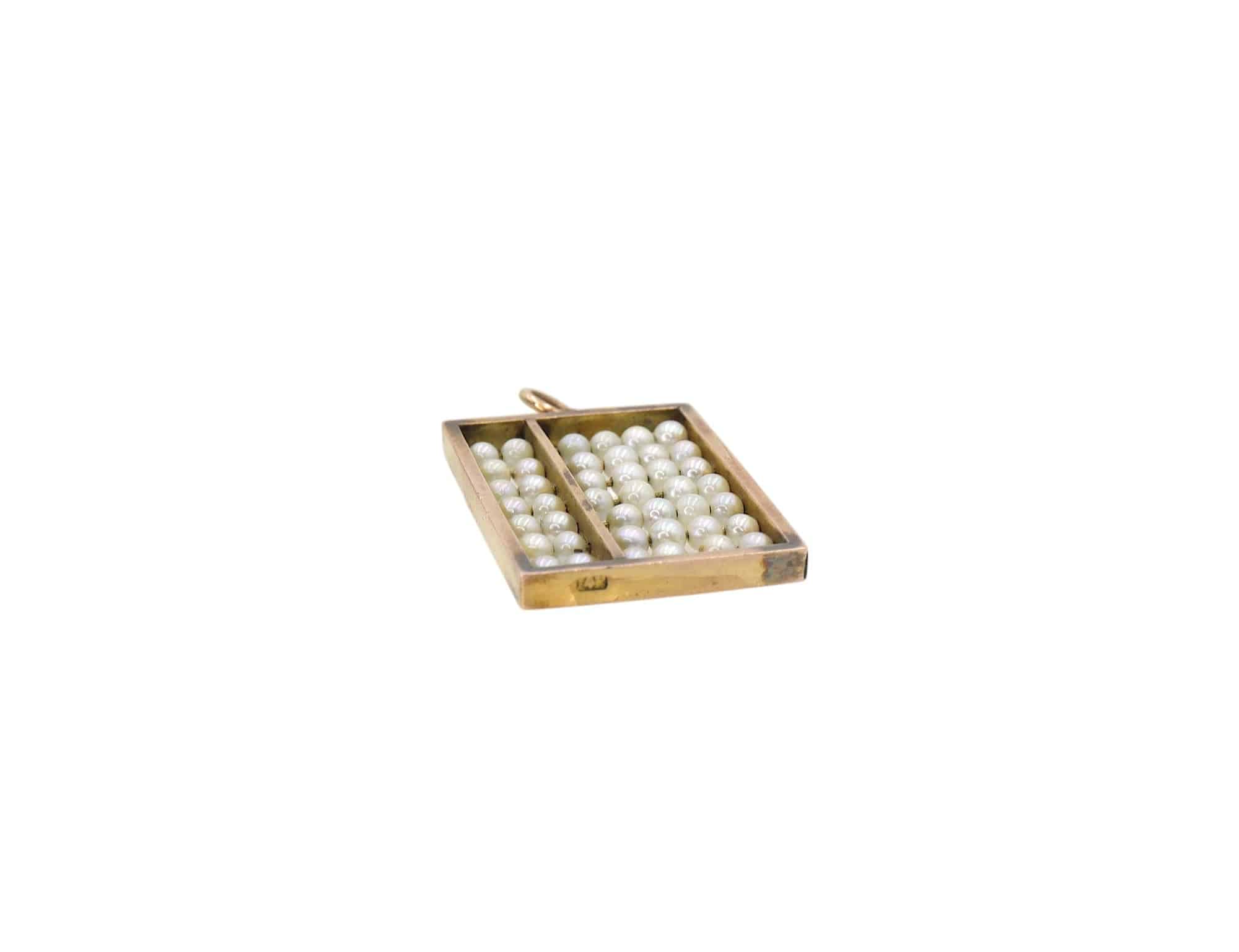 Antique 14k gold abacus pendant with sliding pearls, vintage jewelry piece showing intricate design and pearl accents.