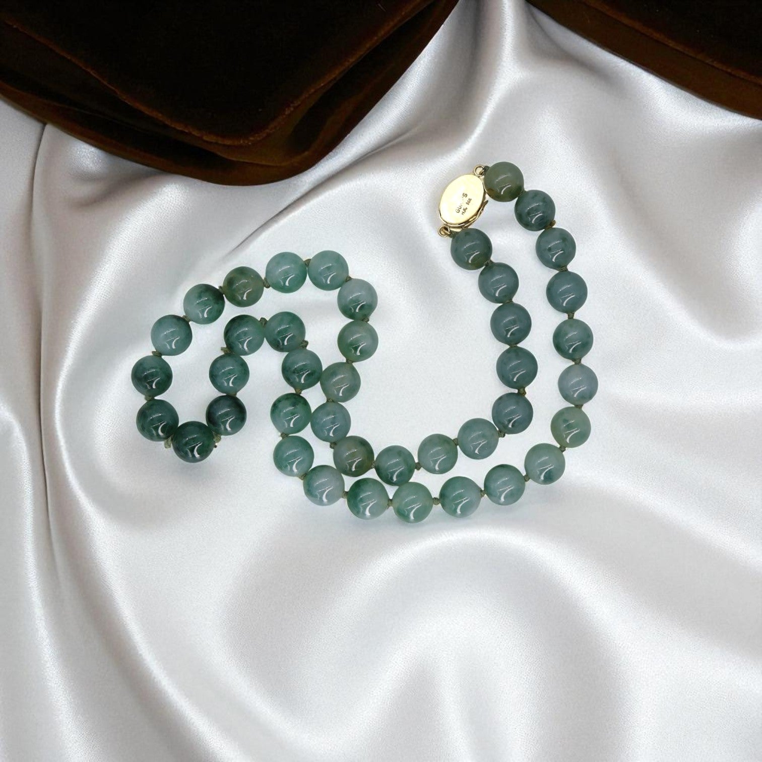 Vintage 1960s Jade bead necklace by Gump’s San Francisco featuring 14k gold clasp, 24-inch length, 13mm jade beads.