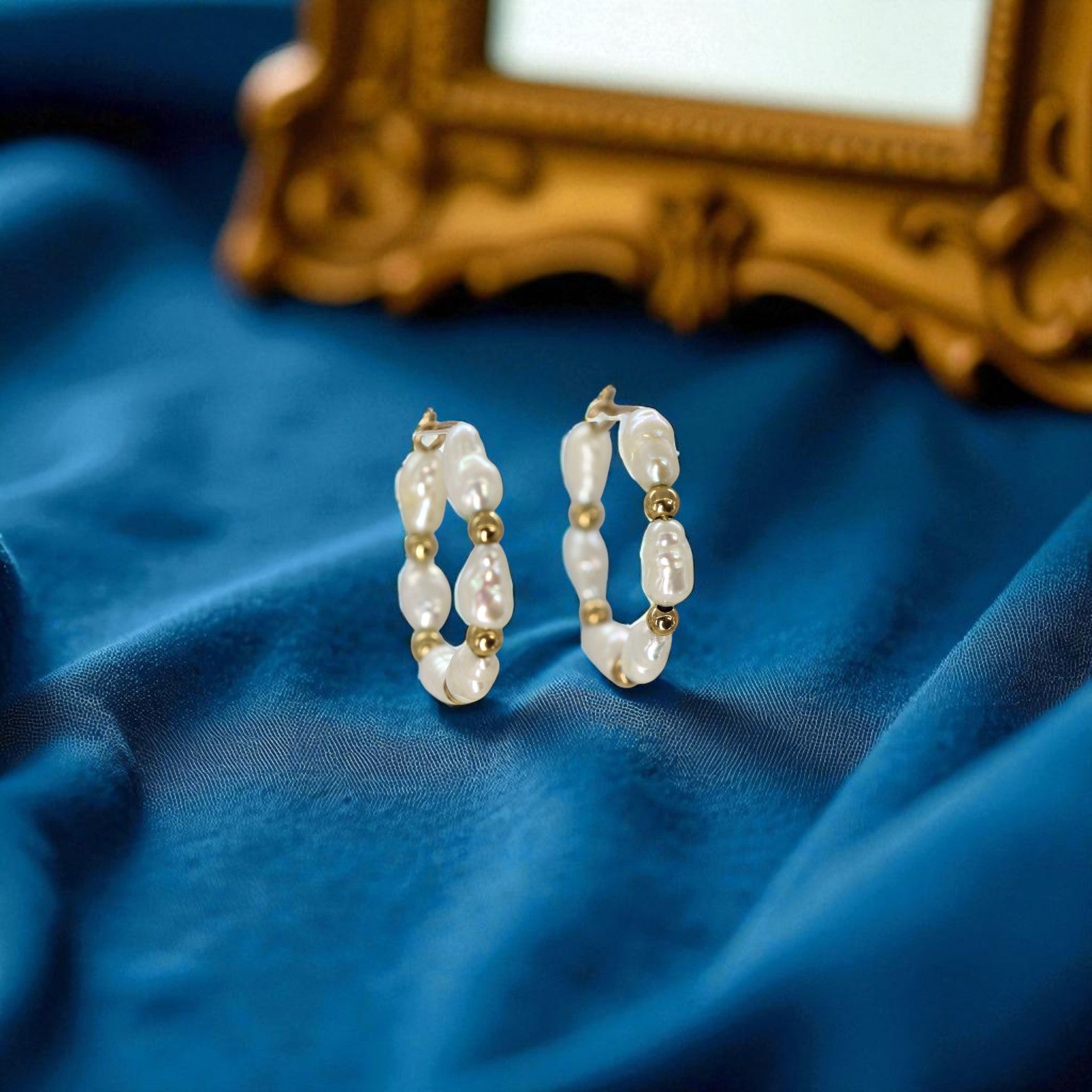 Vintage minimalist 14k gold freshwater pearl hoop earrings with elegant, smooth hoops and lustrous pearls.