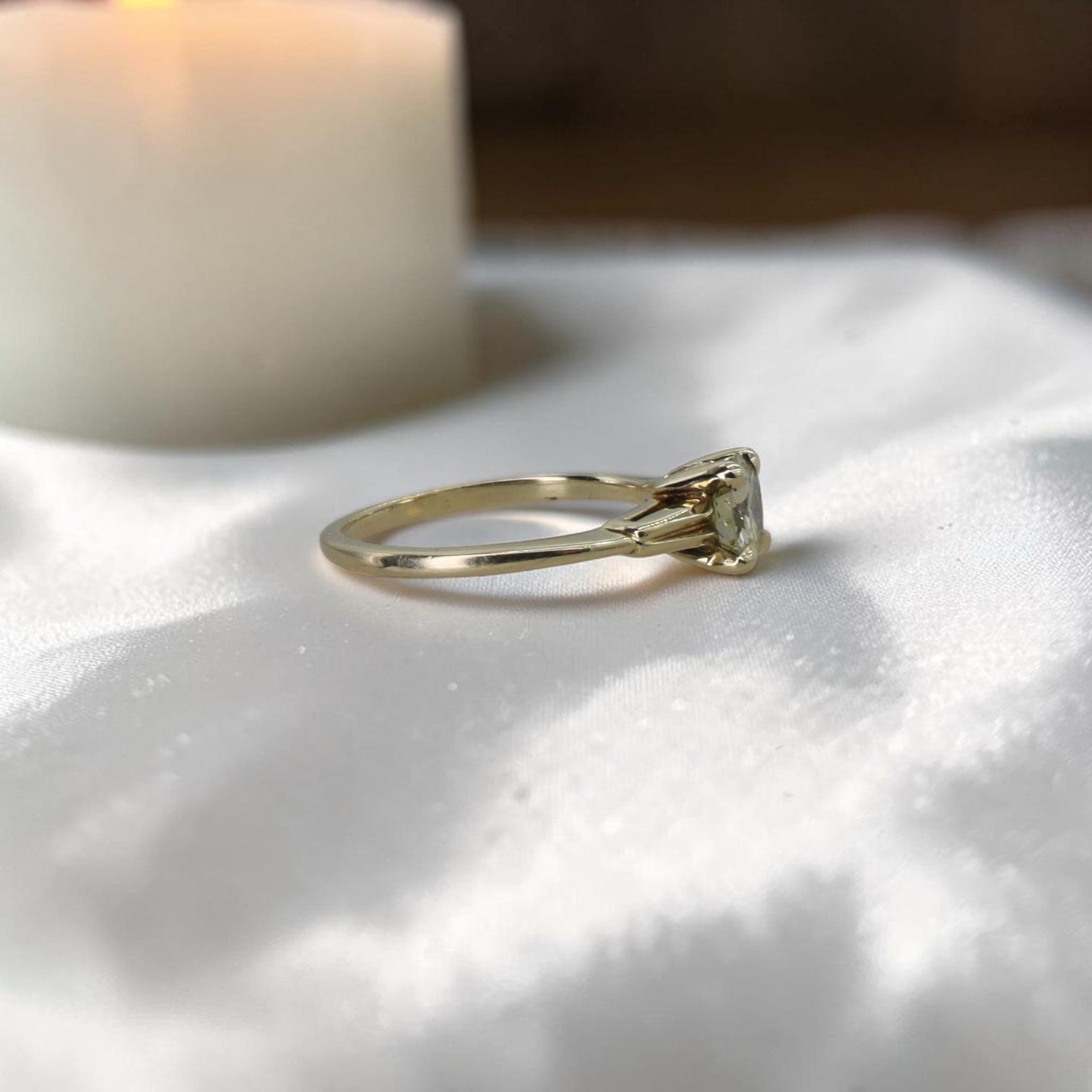 Light yellow diamond solitaire engagement ring by The Vintage Vault featuring a retro fancy cut diamond on a sleek band.