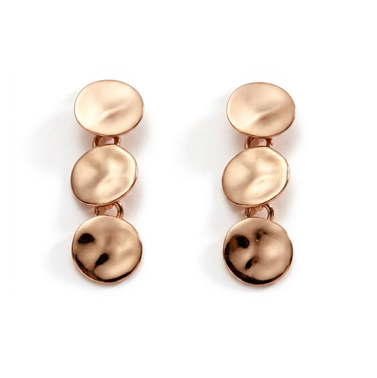 A pair of rose gold drop earrings, each composed of three vertically stacked, textured circular disc charms, shown on a clean white background.