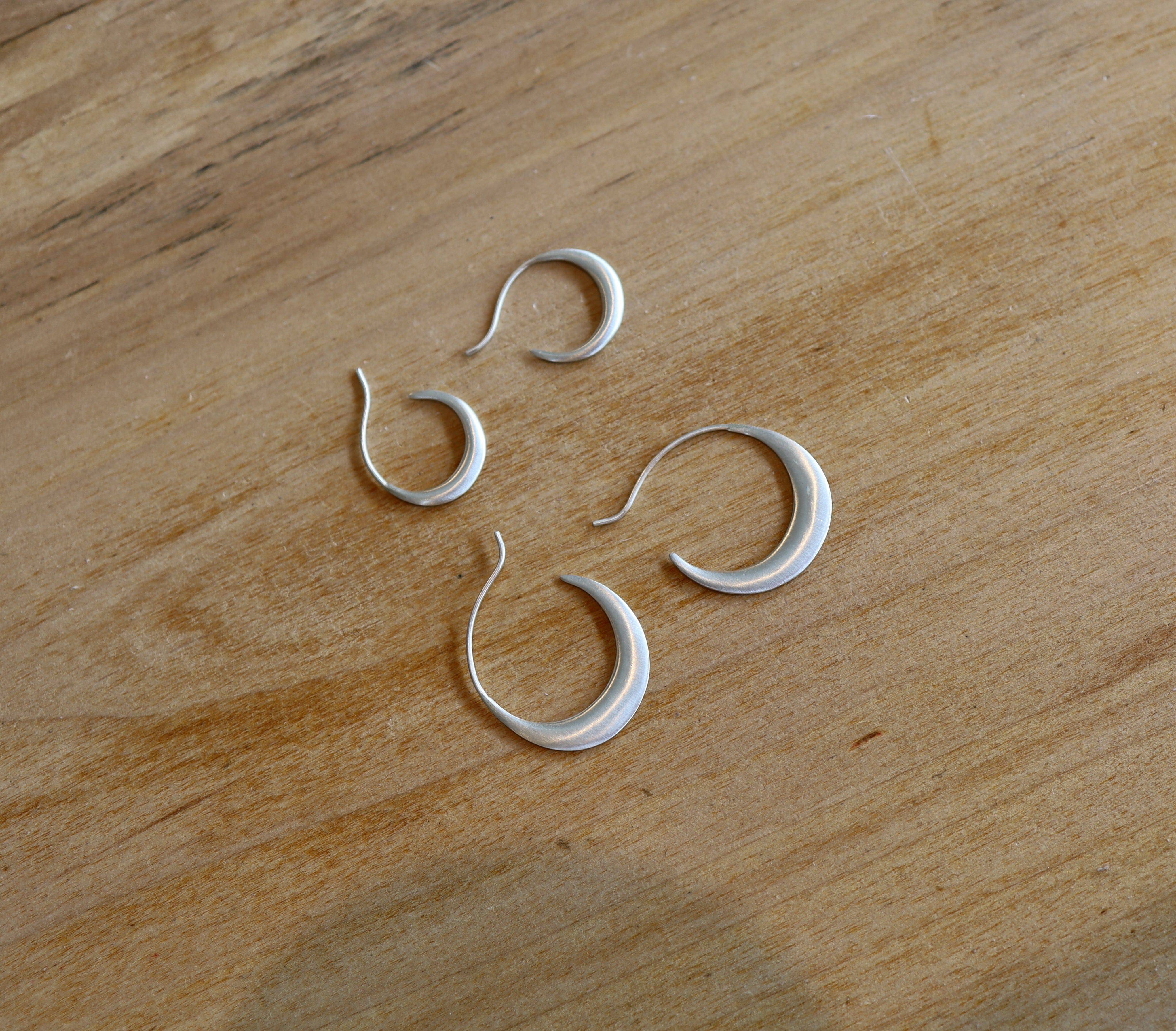 Silver Sade hoops earrings by dan-yell, featuring sleek, circular design with a polished finish.