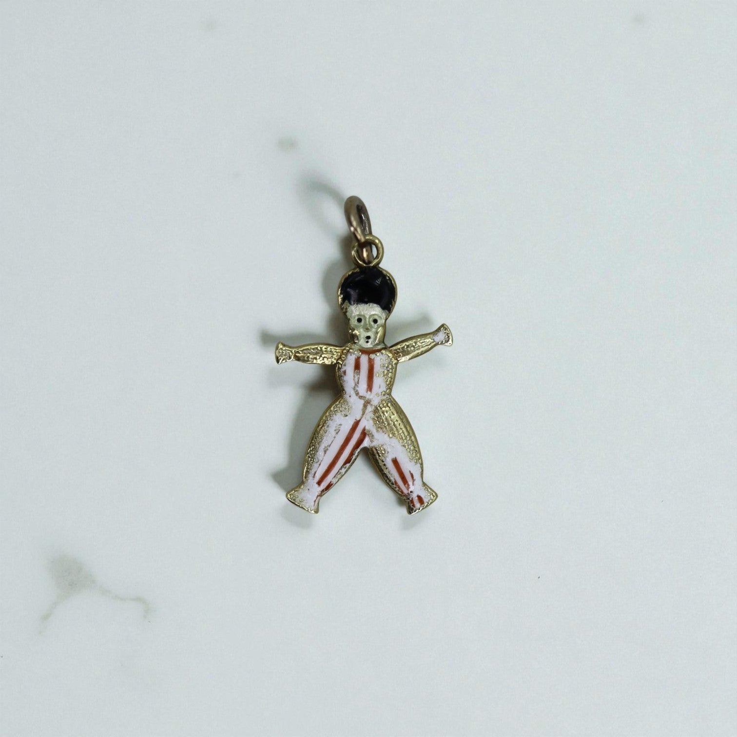 Antique 14k gold charm featuring a historical slave symbol, crafted by The Vintage Vault, showcasing intricate design details.