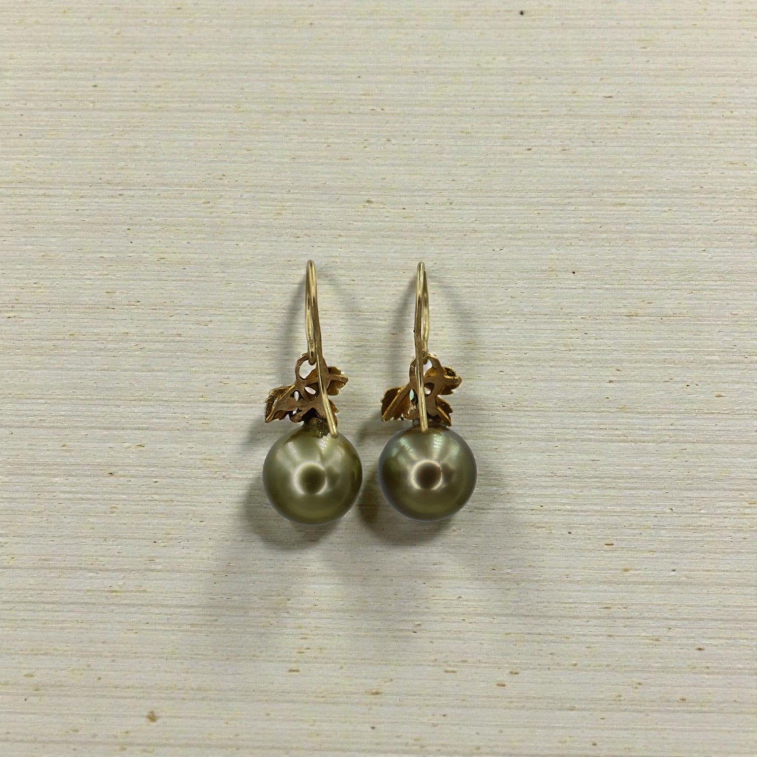 Art Nouveau Tahitian Pearl Earrings in 18k yellow gold featuring dark, lustrous pearls with intricate gold detailing.