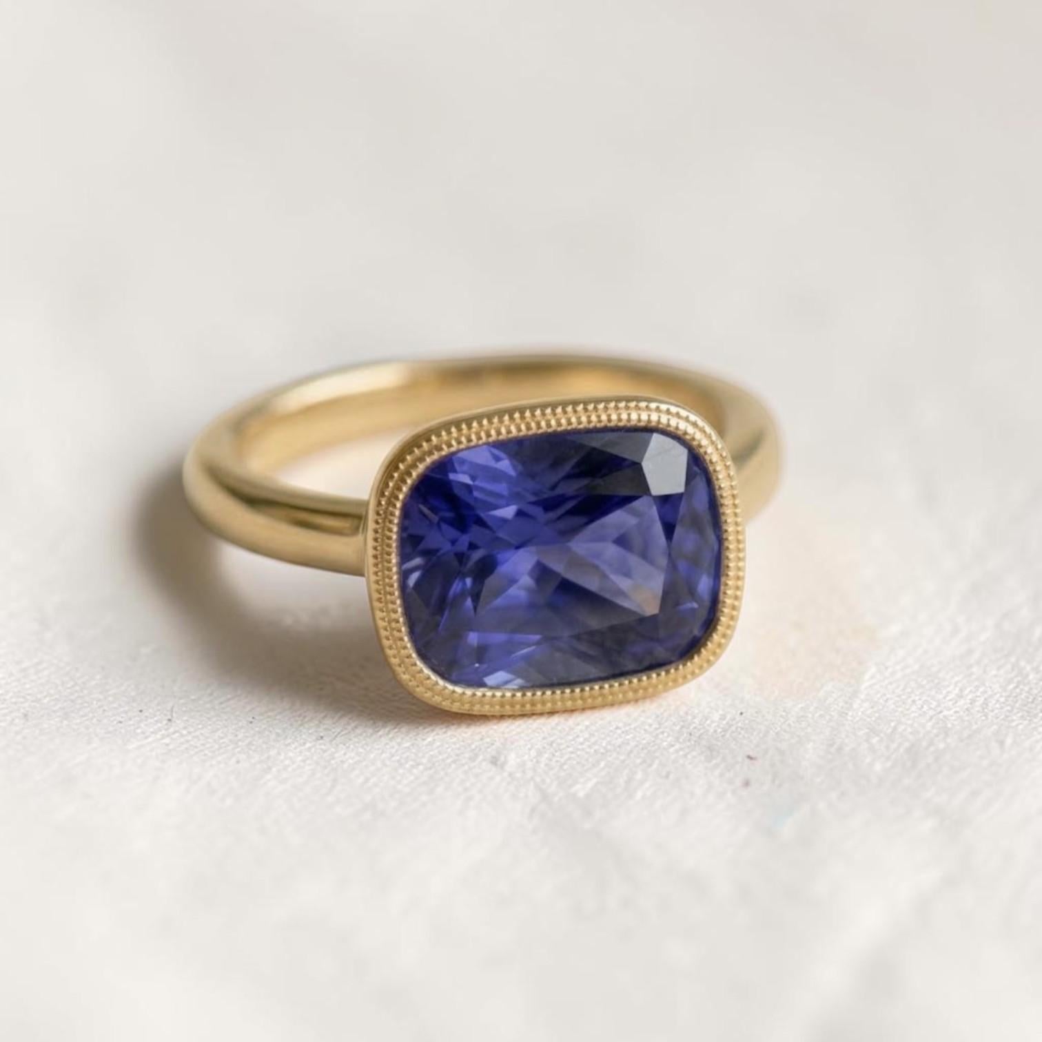Cushion-cut tanzanite gemstone in a 14k yellow gold solitaire mounting, custom jewelry piece by Petra Star.