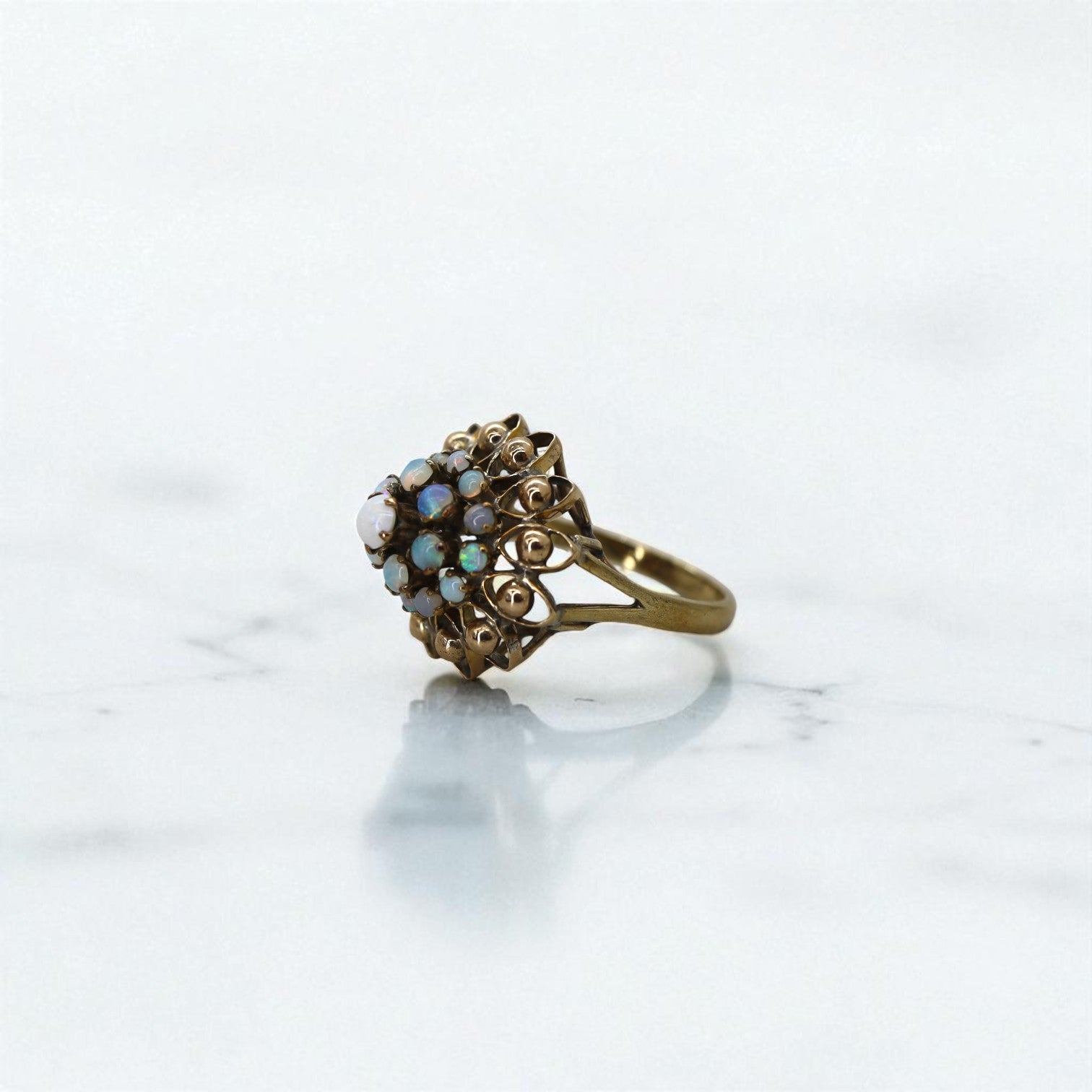 Vintage 1940s white opal cluster harem ring in gold-filled statement cocktail jewelry style, featuring intricate design details.