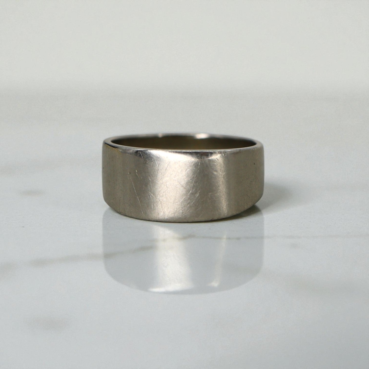 Vintage cigar band ring with gypsy-set diamonds in 14k white gold, featuring intricate detailing and a classic design.