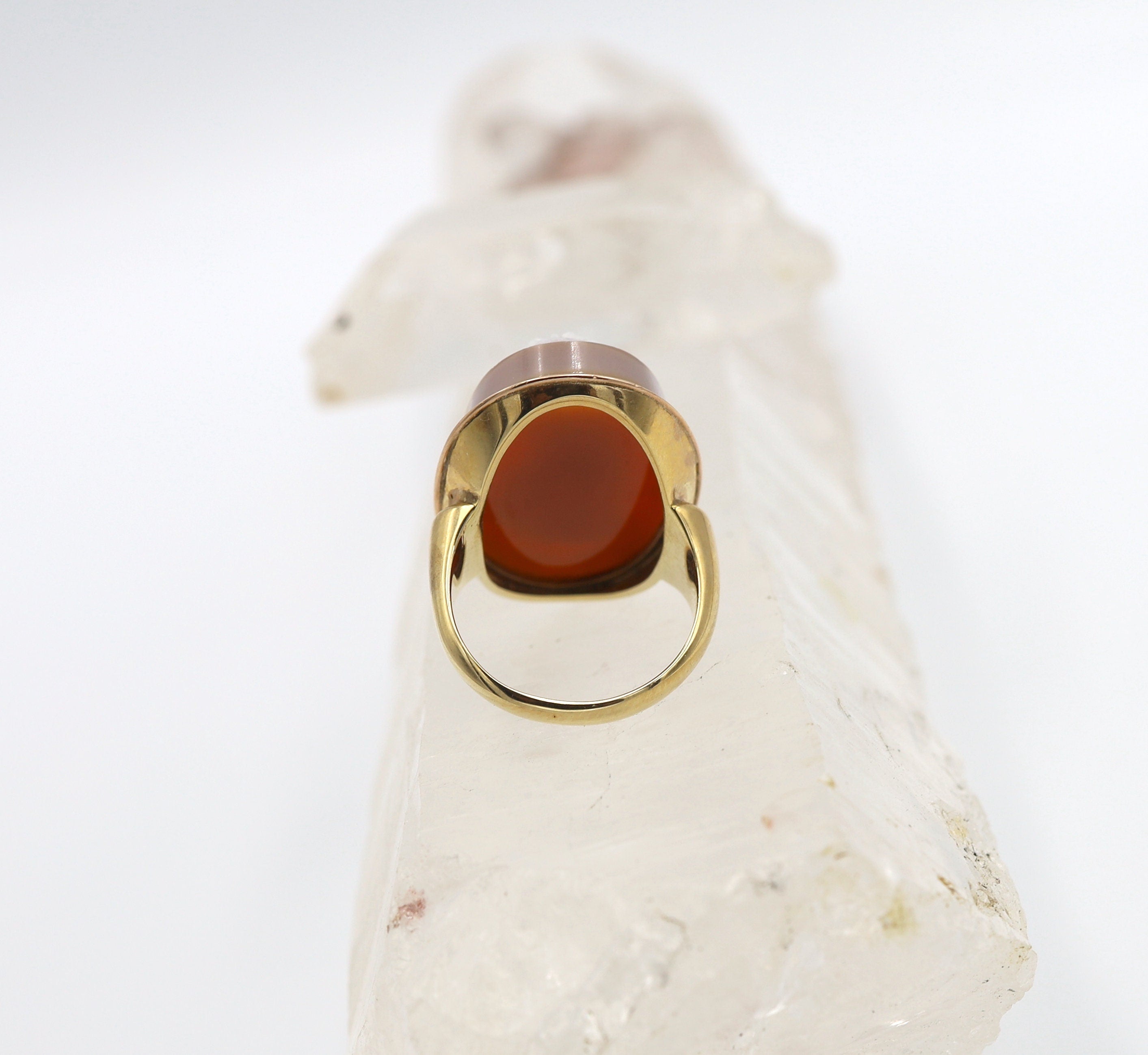 Victorian-style stone cameo ring with carved agate set in 14k yellow gold, featuring intricate vintage design.