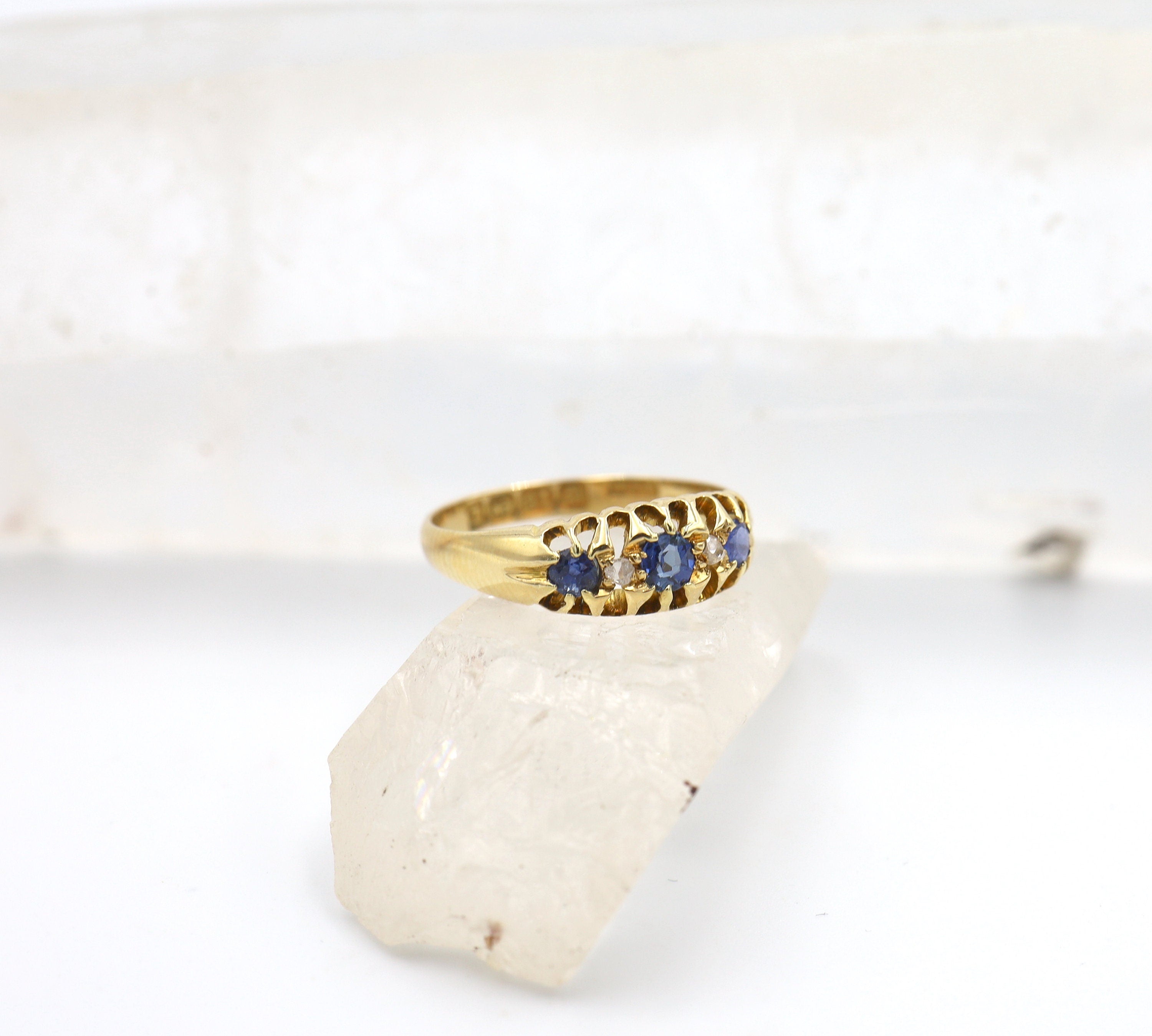 Victorian sapphire and diamond band ring in 18k yellow gold with a Belcher chain design, featuring sparkling blue sapphires and diamonds.