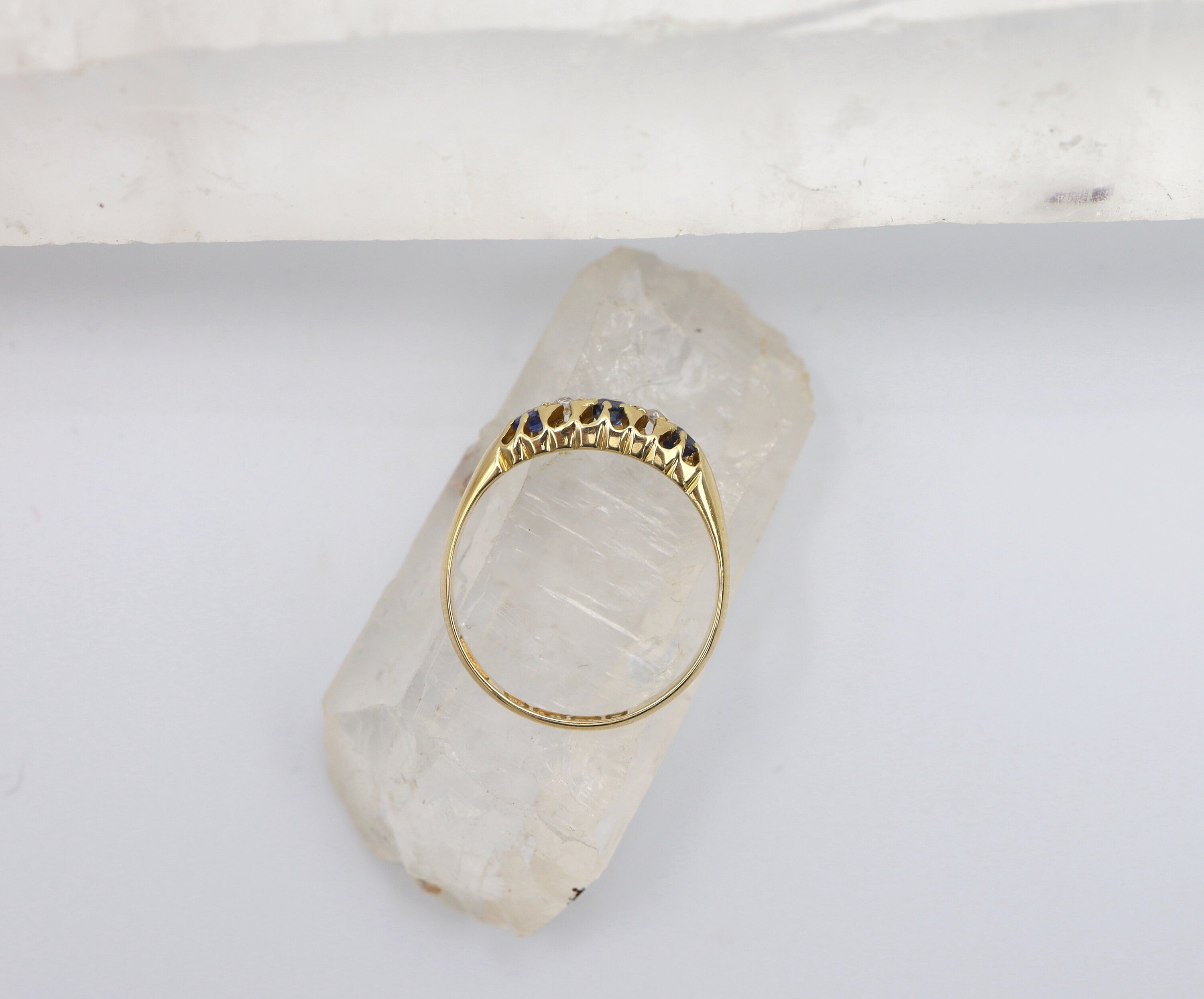 Victorian sapphire and diamond band ring in 18k yellow gold with a belcher style design, featuring blue sapphires and sparkling diamonds.