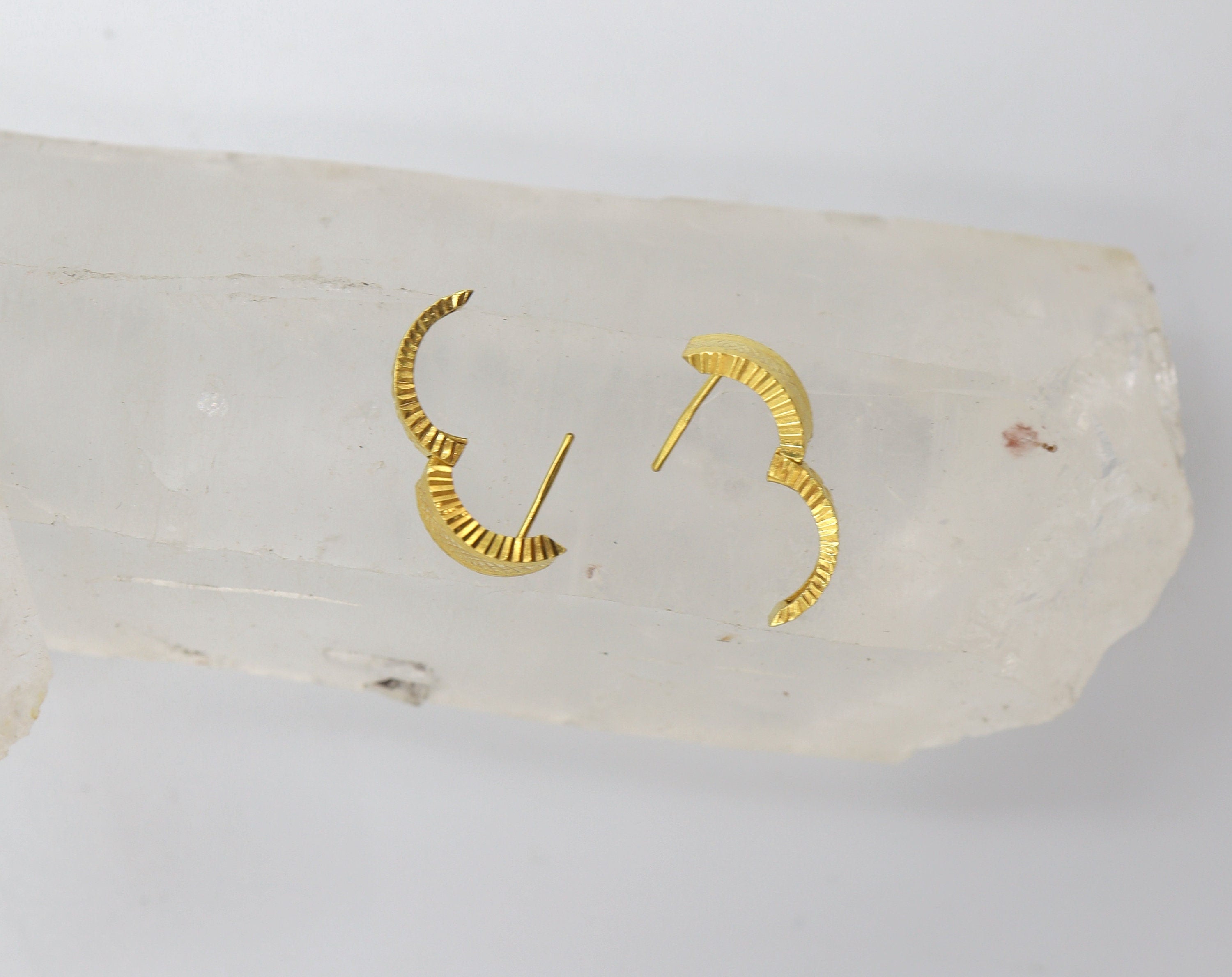 Vintage 22k gold huggie hoop earrings from The Vintage Vault, featuring a classic, polished design in close-up view.