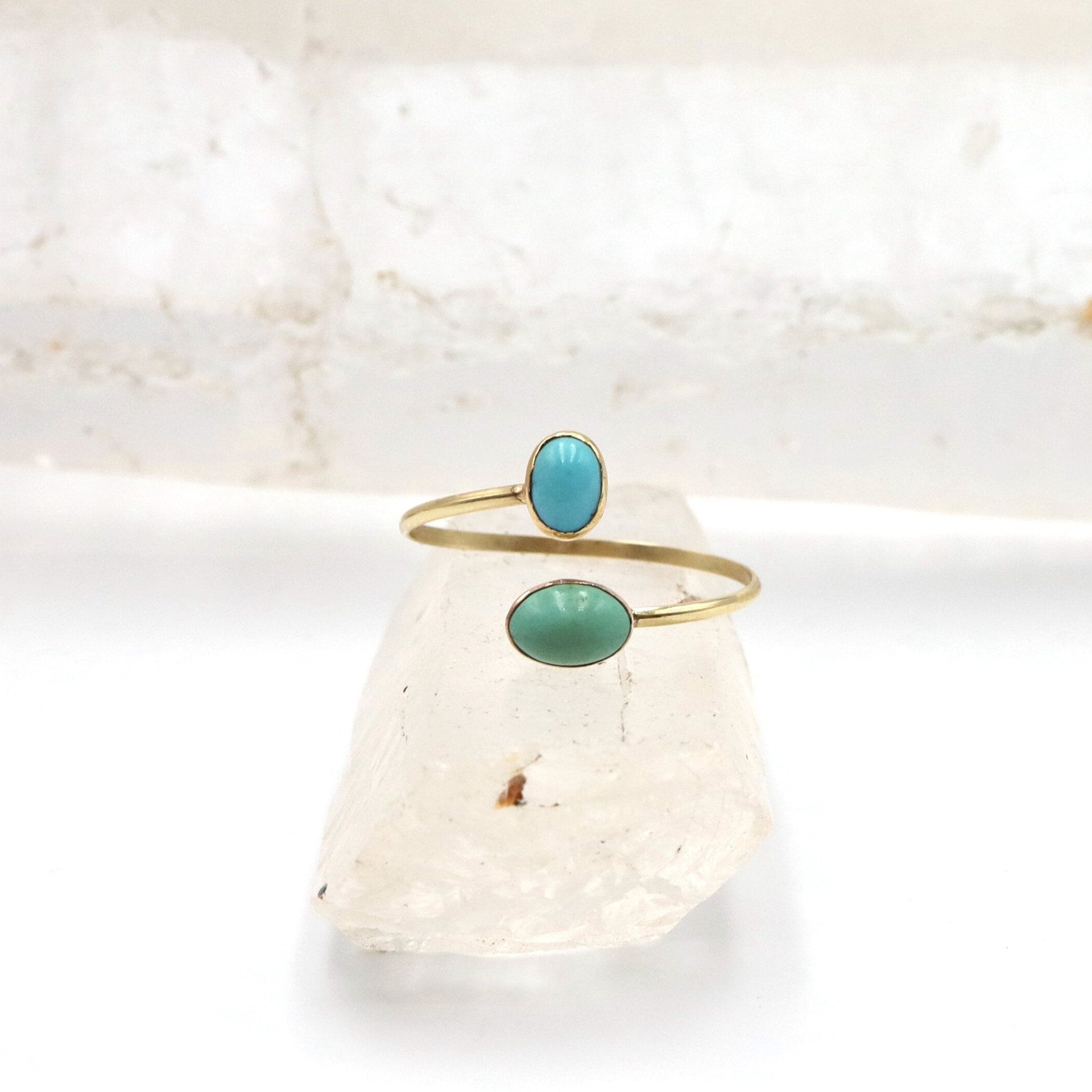 Victorian turquoise Toi et Moi ring by The Vintage Vault featuring two oval turquoise stones set in vintage gold-tone metal.