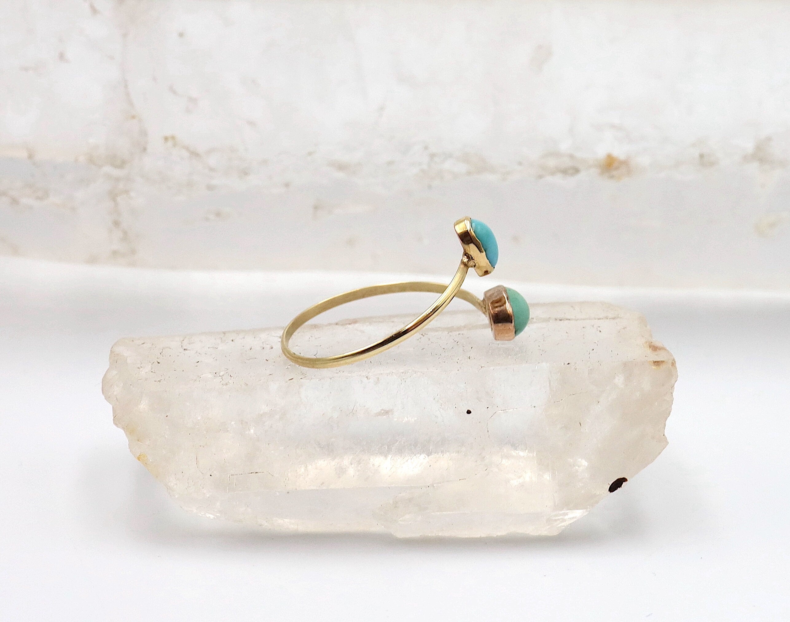 Victorian turquoise Toi et Moi ring by The Vintage Vault featuring two oval turquoise cabochons set in ornate gold band
