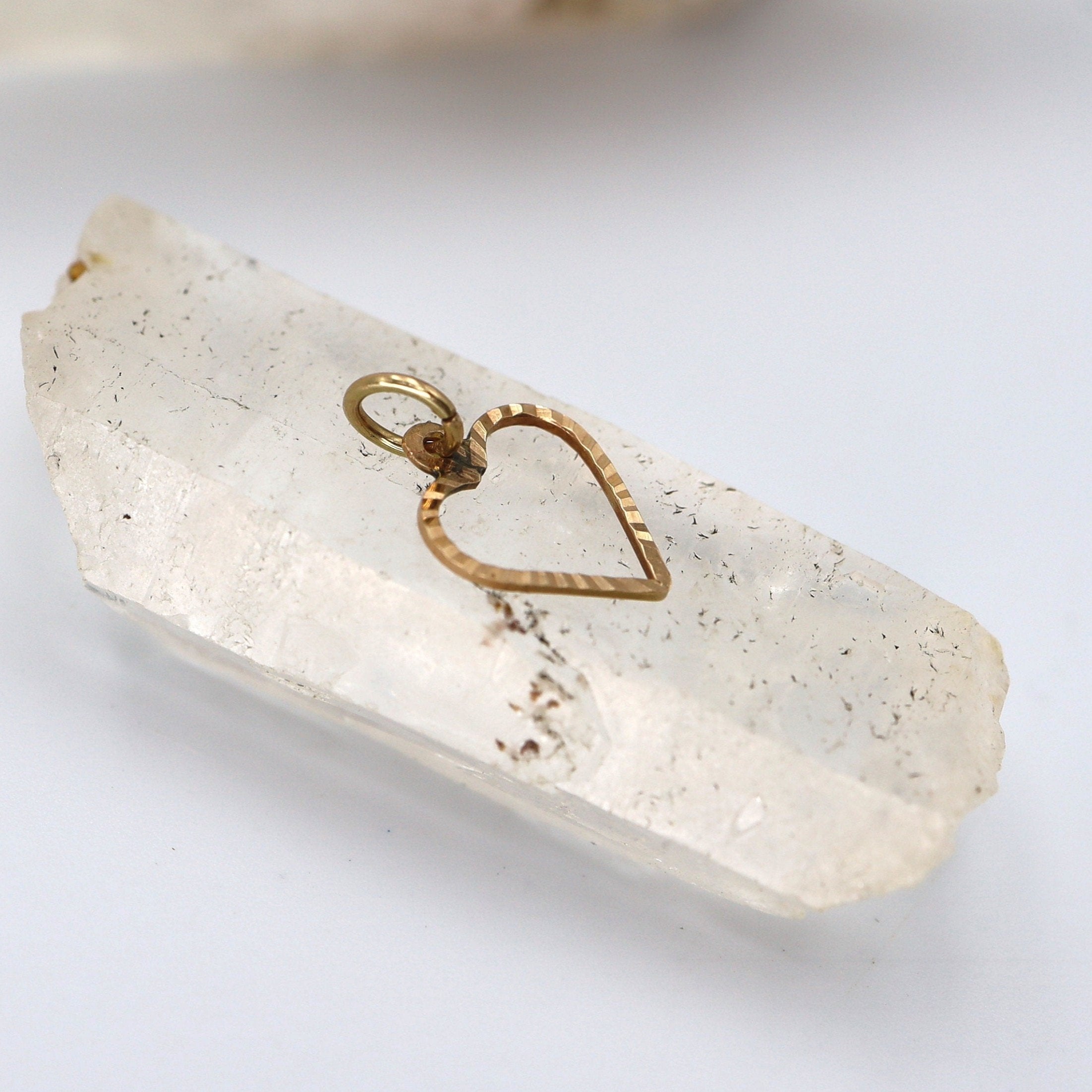 Vintage Heart Charm in 14k yellow gold with intricate detailing, perfect for jewelry or charm bracelets.