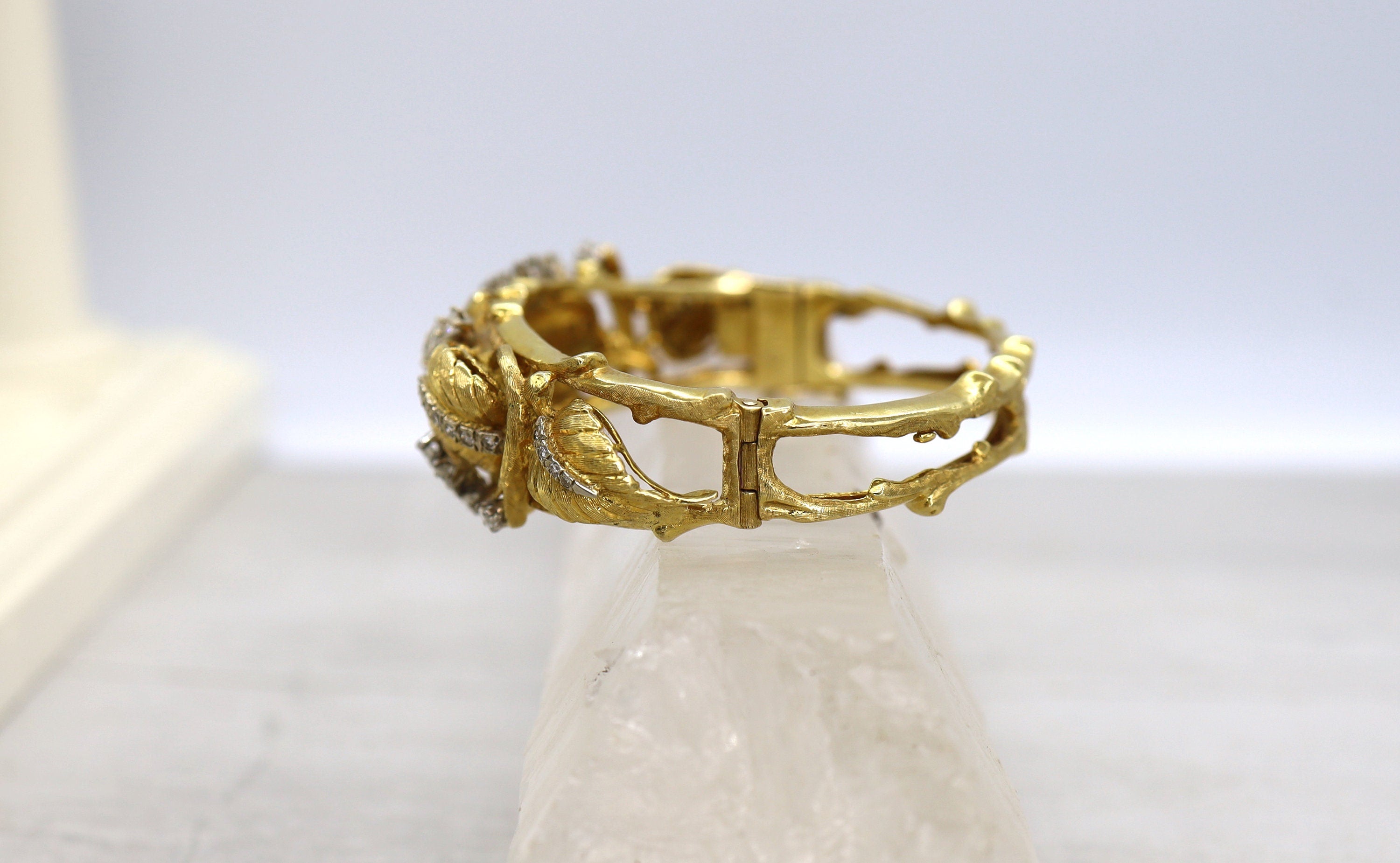 Vintage 1950s Jack Gutschneider 18k diamond bracelet featuring intricate gold design and sparkling diamonds.
