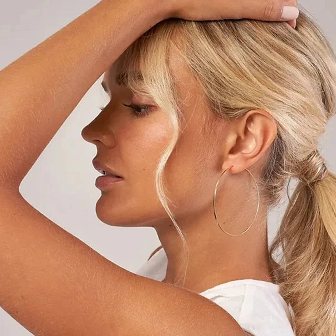 Large hoop earrings by Petra Star from the Endless Summer collection, featuring sleek, polished metal hoops.