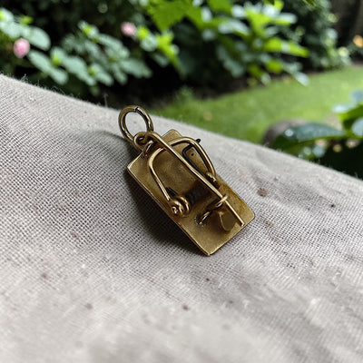 Vintage 14k gold mousetrap charm pendant on a bracelet, featuring detailed craftsmanship and a whimsical design.