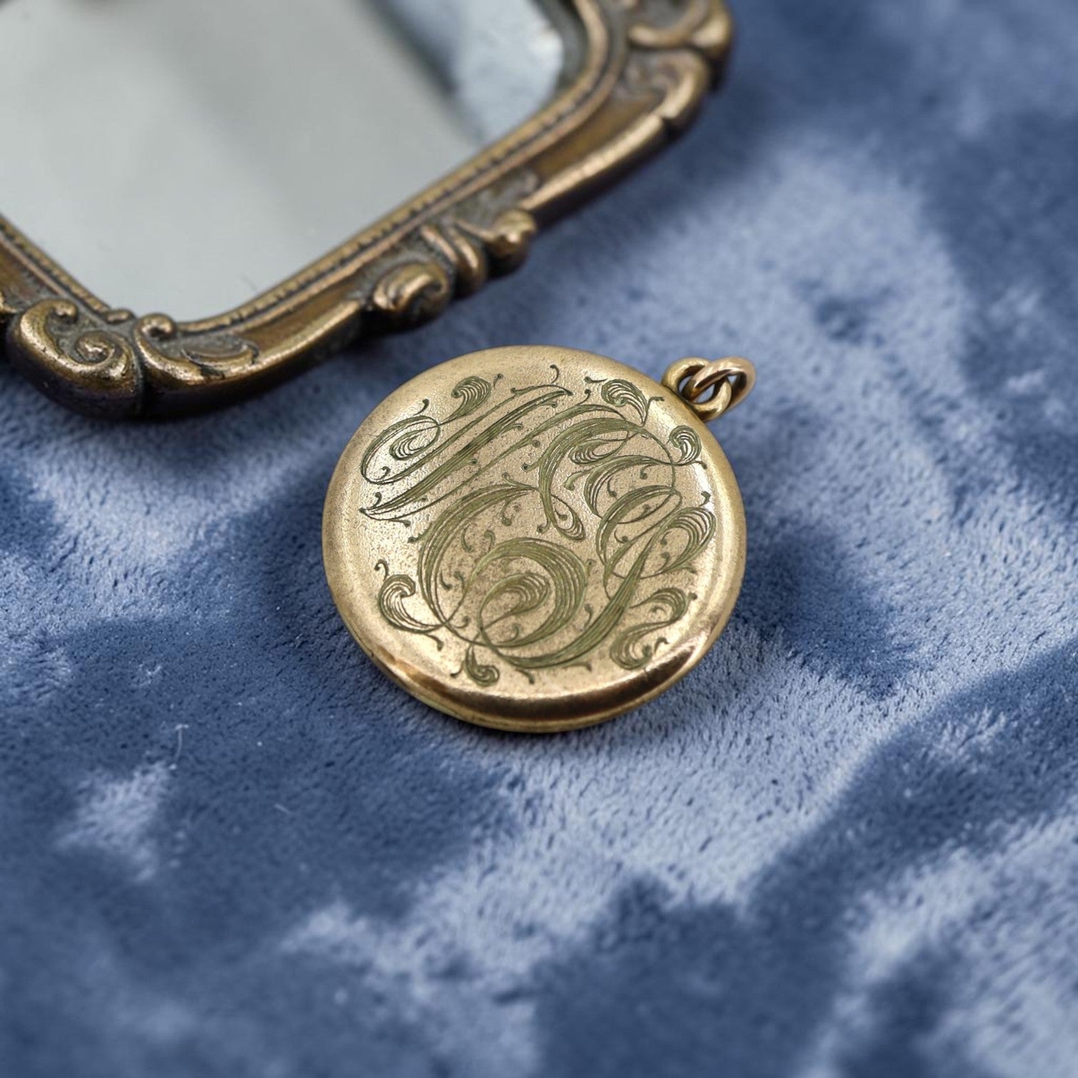 Vintage Art Nouveau gold-filled lion pendant locket with paste stones, circa 1905, monogrammed NES, featuring intricate design details.