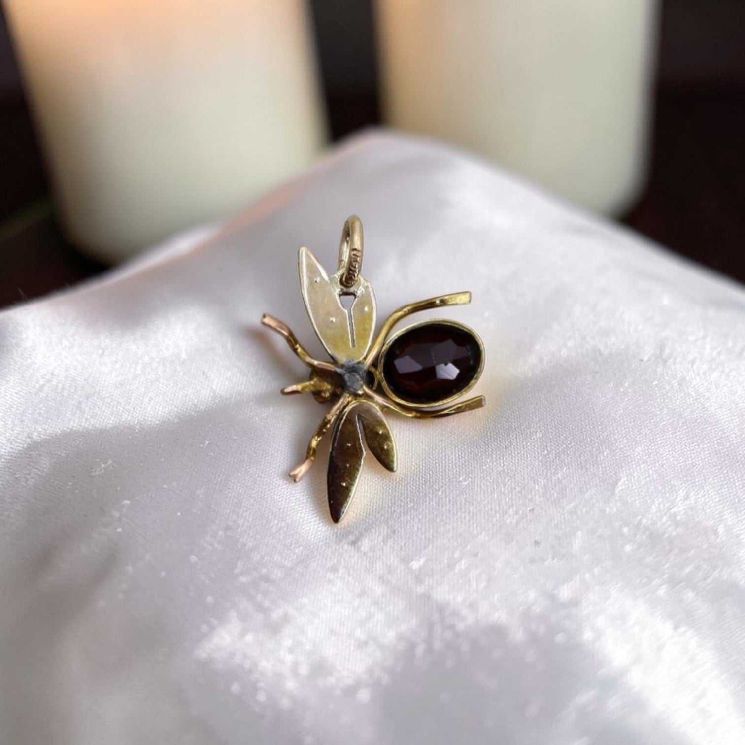 Close-up of Victorian Garnet Pearl Insect Pendant featuring a pearl wing and intricate vintage design.