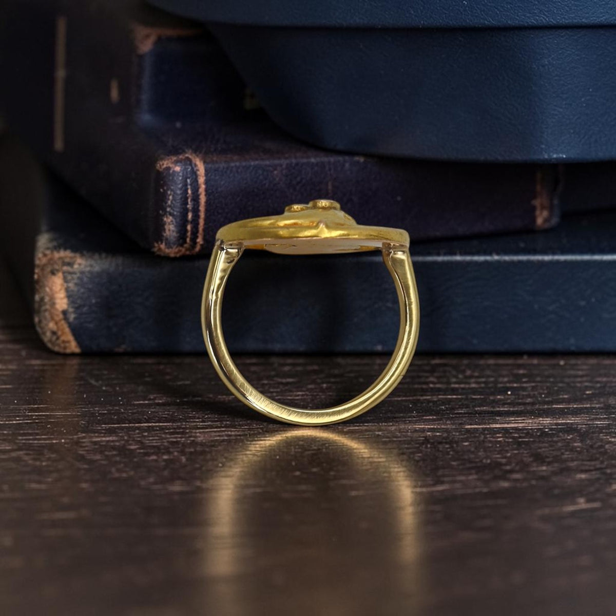 Profile view of the 18k gold snake ring standing upright, showing the slim band and how the head sits on the finger