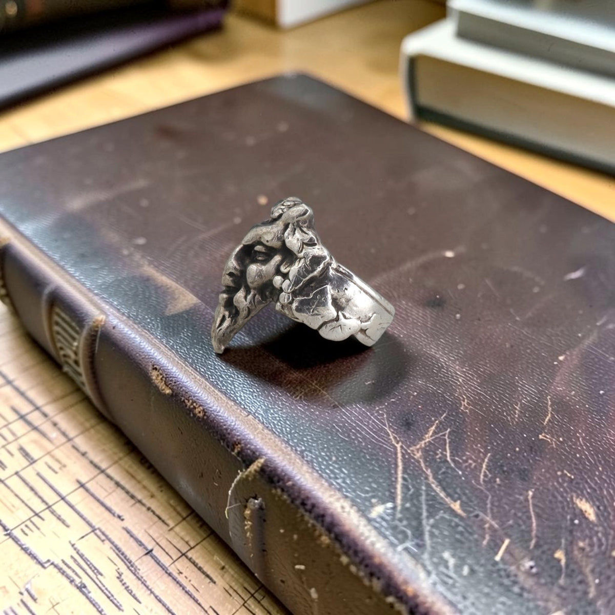 Antique silver satyr ring in profile showing the leaf motif shoulder