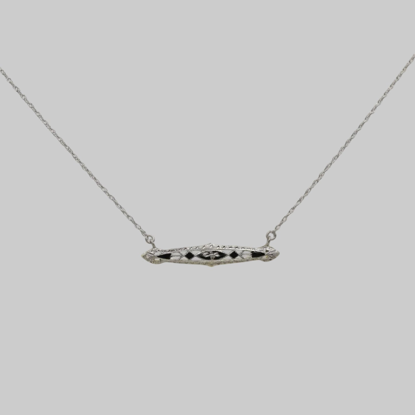Necklace with a bar pendant on a plain background