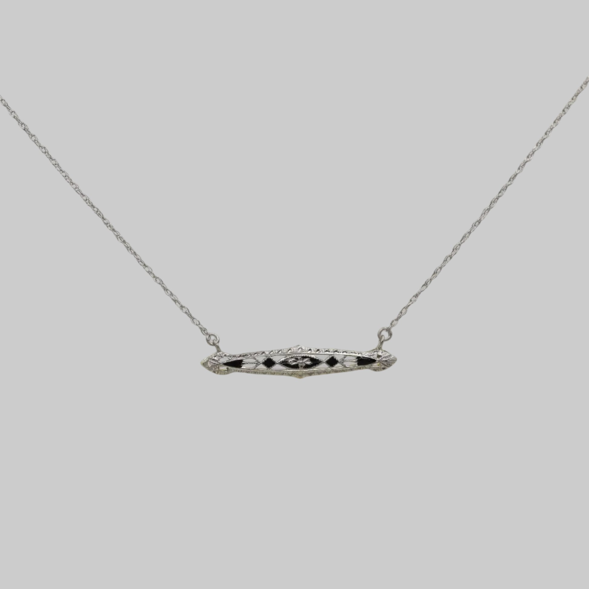 Necklace with a bar pendant on a plain background