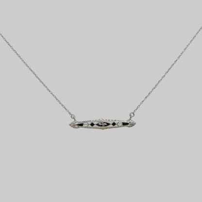 Necklace with a bar pendant on a plain background