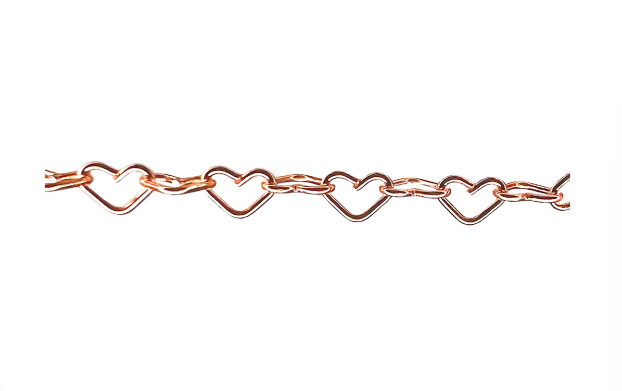 Close-up of rose gold heart-link permanent jewelry chain by Petra Star, featuring alternating heart-shaped and oval links.