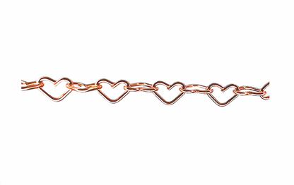 Close-up of rose gold heart-link permanent jewelry chain by Petra Star, featuring alternating heart-shaped and oval links.
