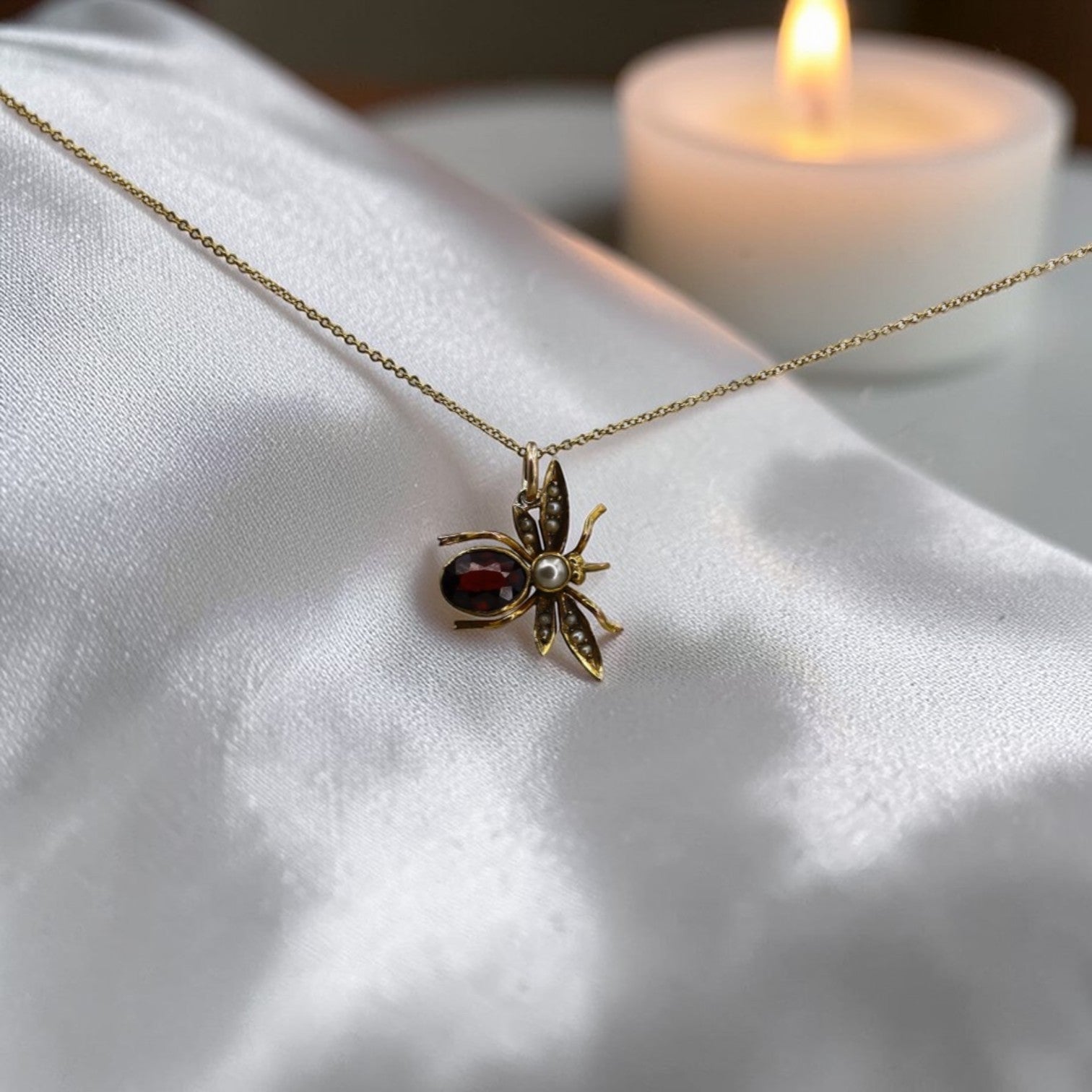 Victorian Garnet Pearl insect pendant featuring intricate metalwork, showcasing a vintage Victorian-style jewelry piece.