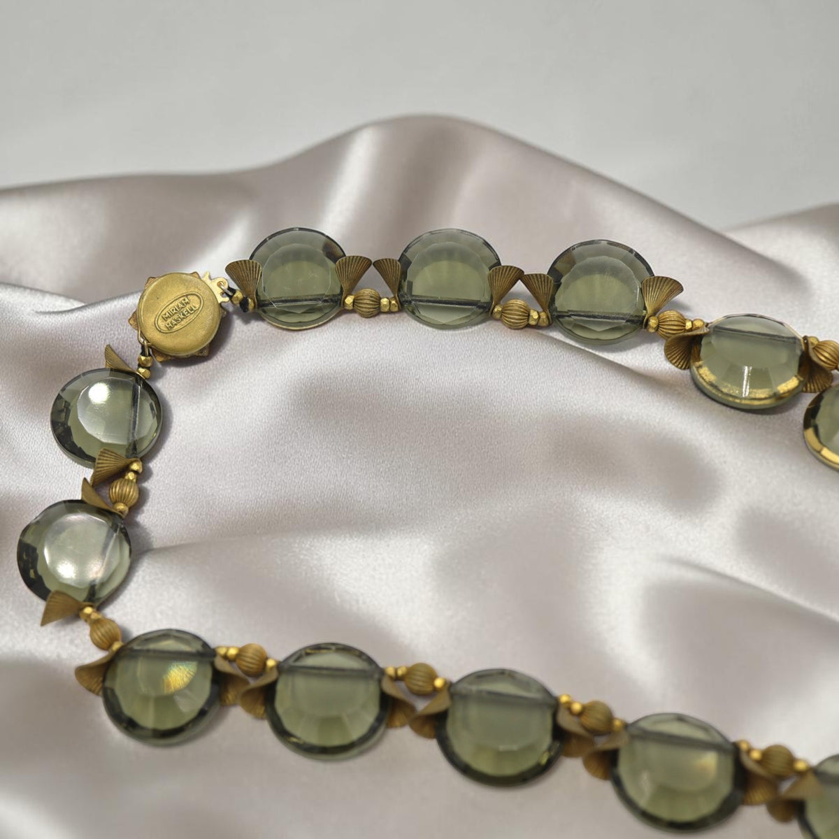 Side view of Miriam Haskell smoky quartz discs linked by gold-plated fan-shaped and round spacer beads